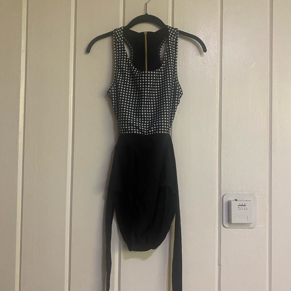 Albion Fit black and white checkered one piece swimsuit.